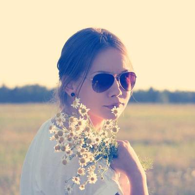 photograph of woman holding bouquet of picked wildflowers