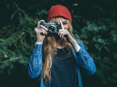 portrait of a woman taking a photograph